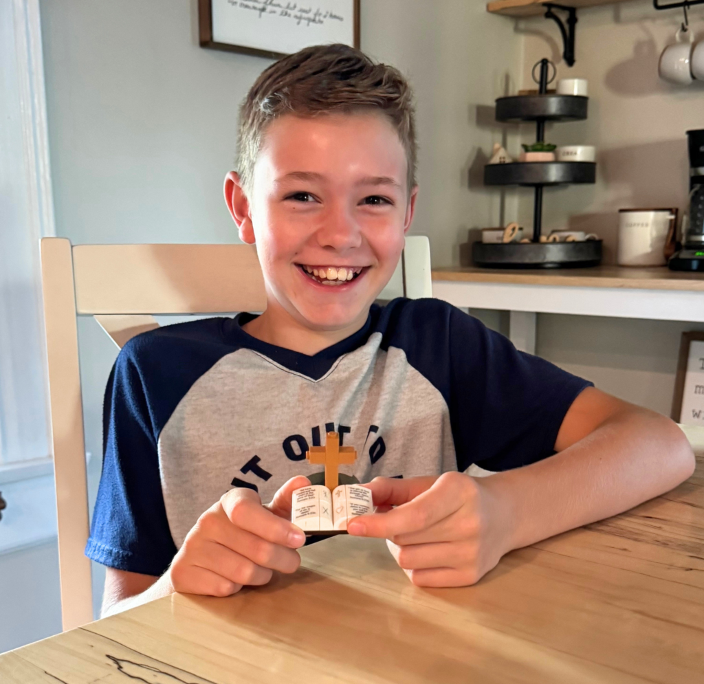 Chile holding the finished Romans Road Lego compatible set